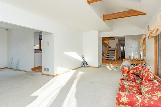 living room featuring lofted ceiling with beams