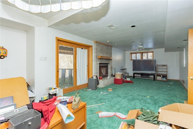 living room with ceiling fan, carpet flooring, and a fireplace