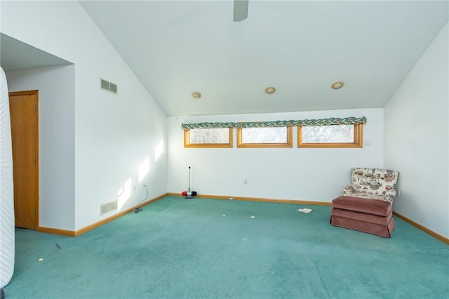 unfurnished room featuring lofted ceiling and carpet floors