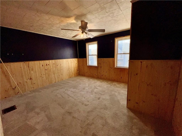 spare room featuring ceiling fan and carpet