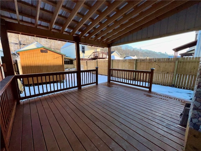 wooden deck featuring a shed