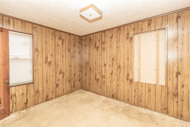 spare room featuring wooden walls
