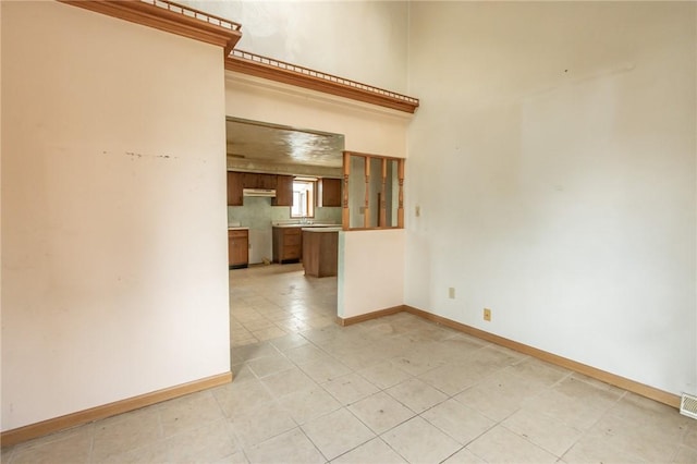empty room featuring baseboards and visible vents