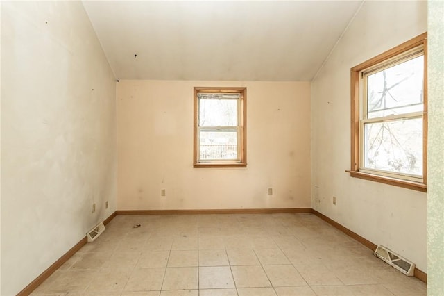 spare room featuring baseboards and visible vents