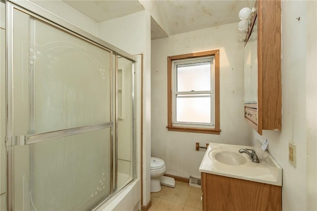 bathroom featuring tile patterned floors, toilet, vanity, baseboards, and visible vents