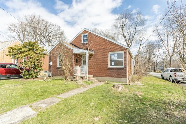 bungalow-style house with brick siding and a front lawn