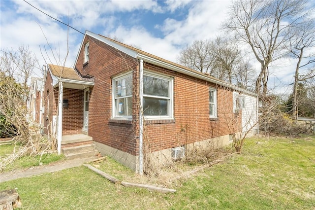 view of side of home with a lawn and brick siding