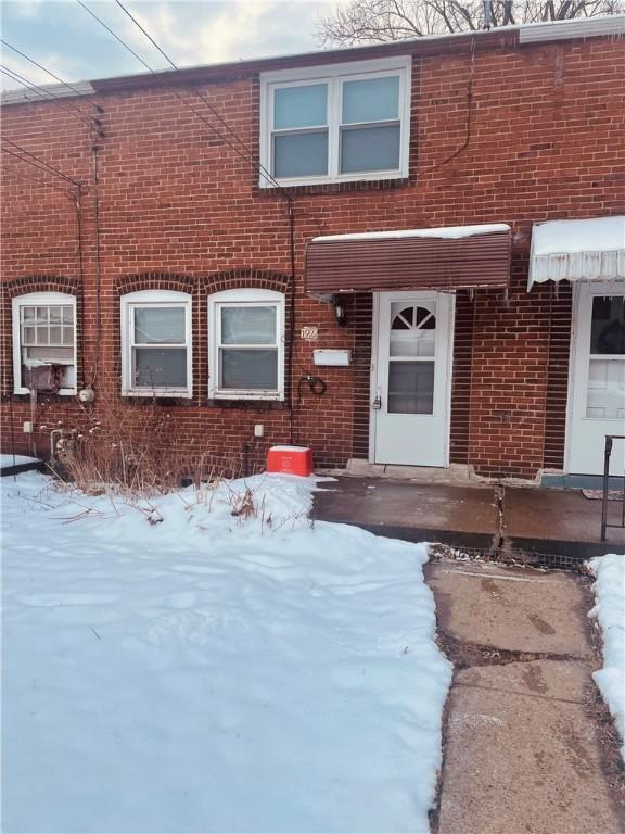 view of snow covered property entrance