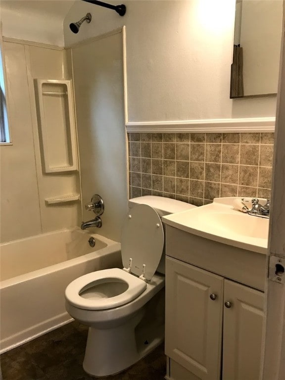 full bathroom with toilet, decorative backsplash, vanity, and shower / bathing tub combination