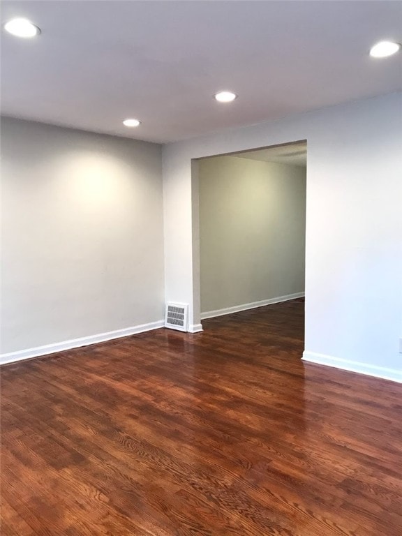 unfurnished room with dark hardwood / wood-style floors