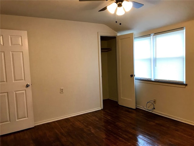 unfurnished bedroom featuring vaulted ceiling, ceiling fan, a closet, and dark hardwood / wood-style floors