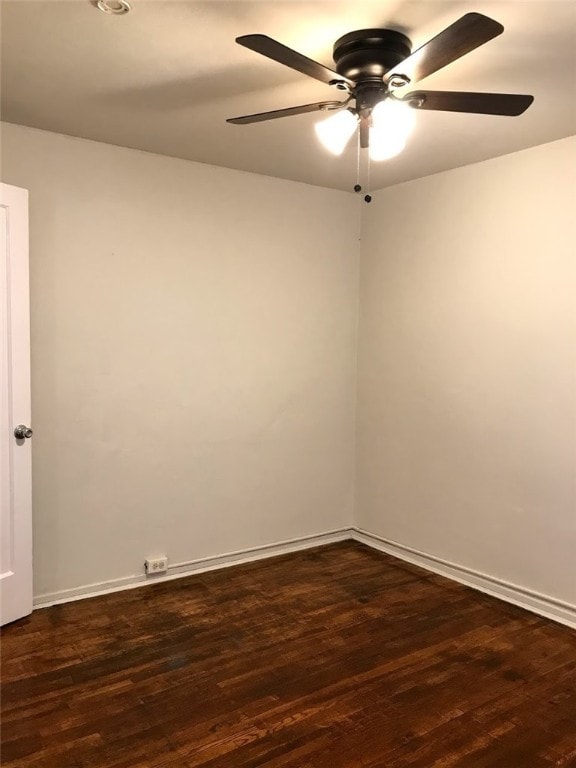 empty room featuring ceiling fan and dark wood-type flooring