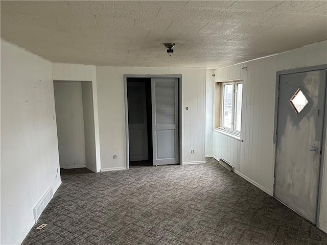 entryway with dark carpet