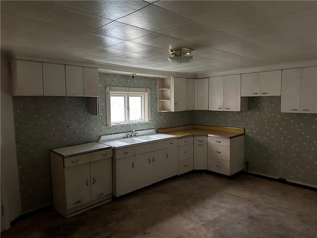 kitchen featuring sink and white cabinetry