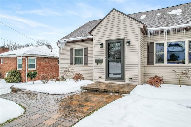 view of snow covered property entrance