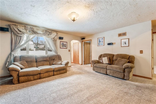 living room with a textured ceiling and carpet floors