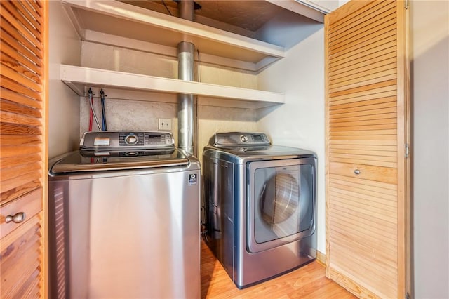 clothes washing area featuring light hardwood / wood-style flooring and independent washer and dryer