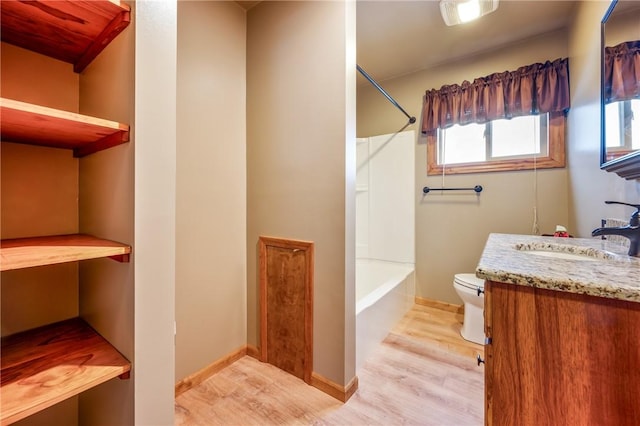 full bathroom with tub / shower combination, wood-type flooring, toilet, and vanity