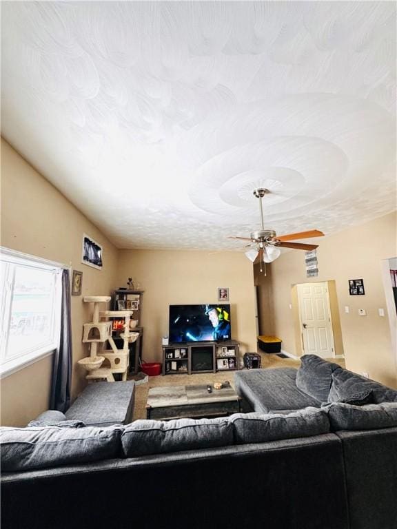 living room featuring vaulted ceiling and ceiling fan