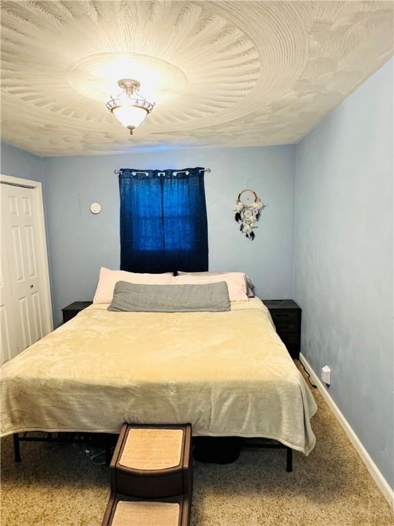 carpeted bedroom with a closet