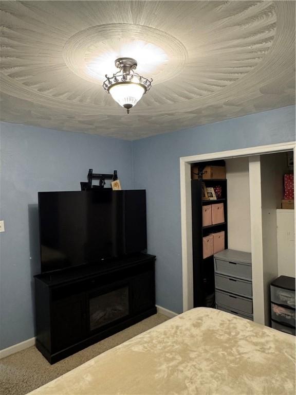 bedroom with light carpet and a closet