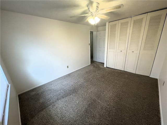 unfurnished bedroom with ceiling fan, a closet, and dark carpet