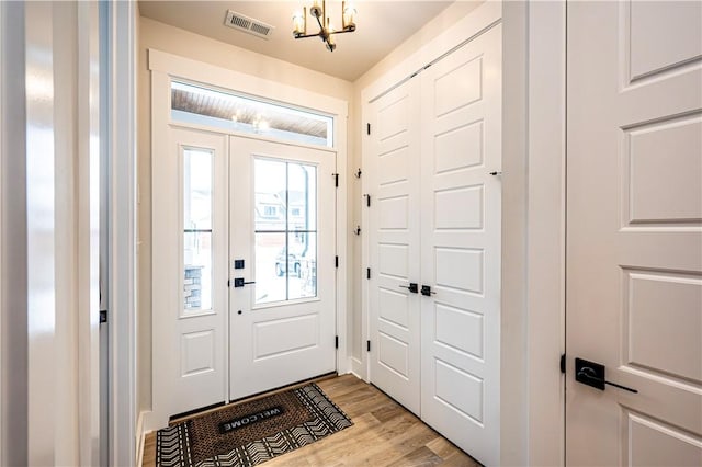 foyer entrance with light hardwood / wood-style floors