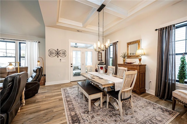 dining room featuring crown molding, an inviting chandelier, hardwood / wood-style floors, beam ceiling, and coffered ceiling