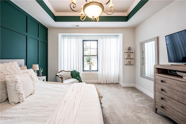 carpeted bedroom featuring ornamental molding, a raised ceiling, and a notable chandelier