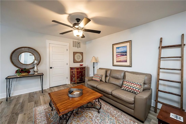 living room featuring hardwood / wood-style flooring and ceiling fan