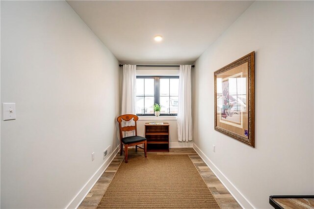 sitting room with wood-type flooring