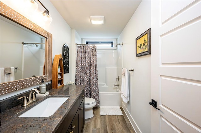full bath with toilet, wood finished floors, vanity, shower / bathtub combination with curtain, and baseboards