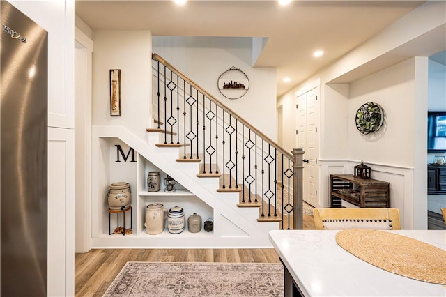 staircase featuring wood-type flooring