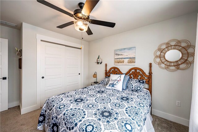 carpeted bedroom with ceiling fan and a closet