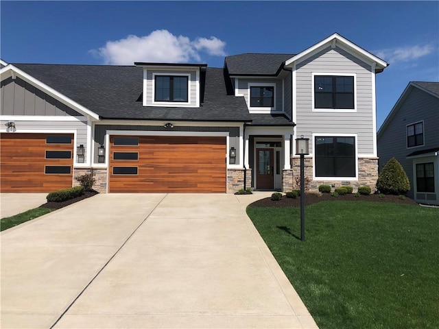 view of front of house featuring driveway, stone siding, and a front yard