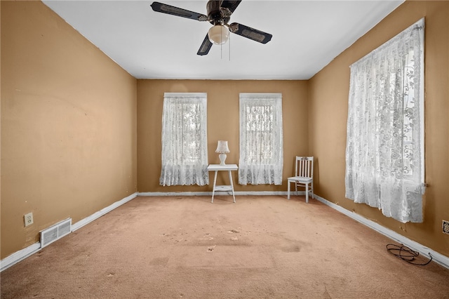 carpeted empty room with ceiling fan