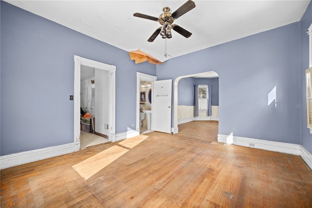 unfurnished room with ceiling fan and light wood-type flooring