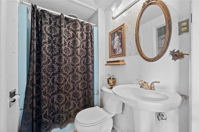 bathroom featuring toilet and curtained shower