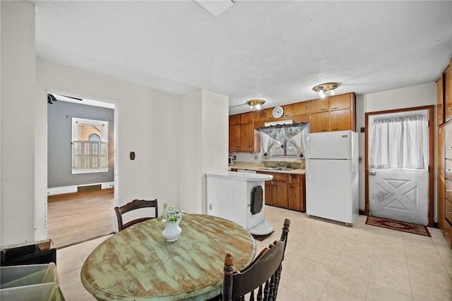 dining room with a textured ceiling and sink