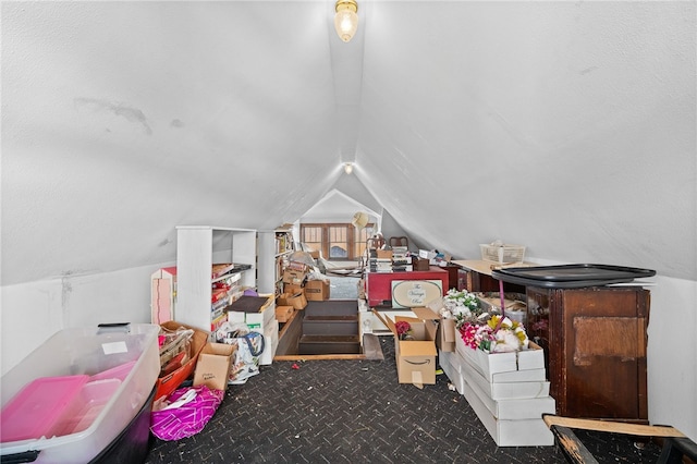 additional living space with lofted ceiling and dark carpet