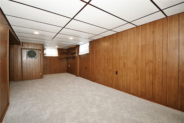 basement with light colored carpet and wooden walls