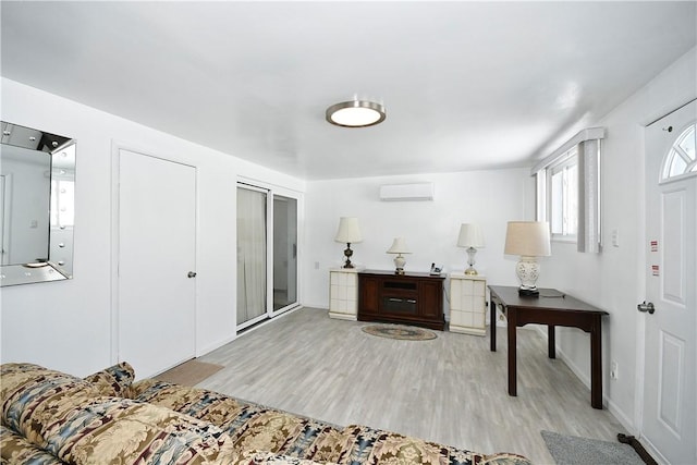 entrance foyer featuring a wall mounted AC and light hardwood / wood-style flooring