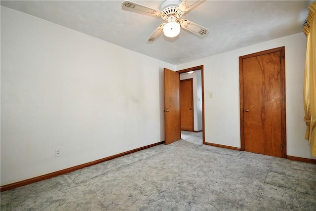 unfurnished bedroom with ceiling fan and light colored carpet