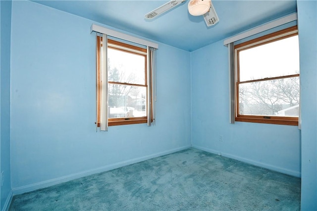 spare room featuring light carpet and ceiling fan