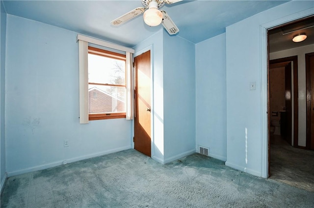 empty room with ceiling fan and light colored carpet