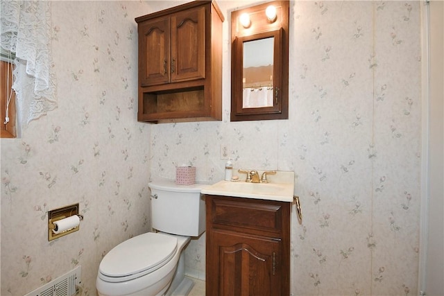 bathroom with toilet and vanity