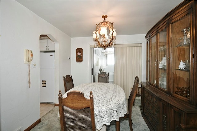 dining space with a notable chandelier