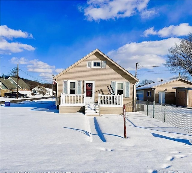 view of snow covered back of property