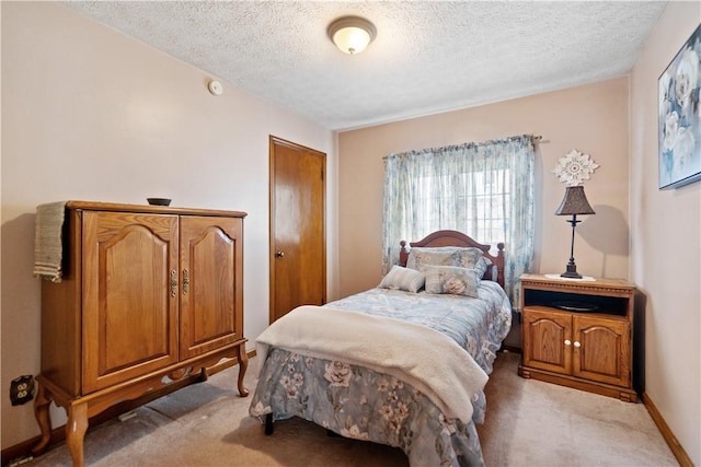 carpeted bedroom featuring a textured ceiling