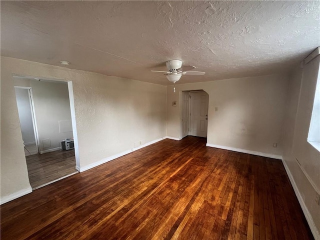 spare room with ceiling fan, dark hardwood / wood-style flooring, and a textured ceiling